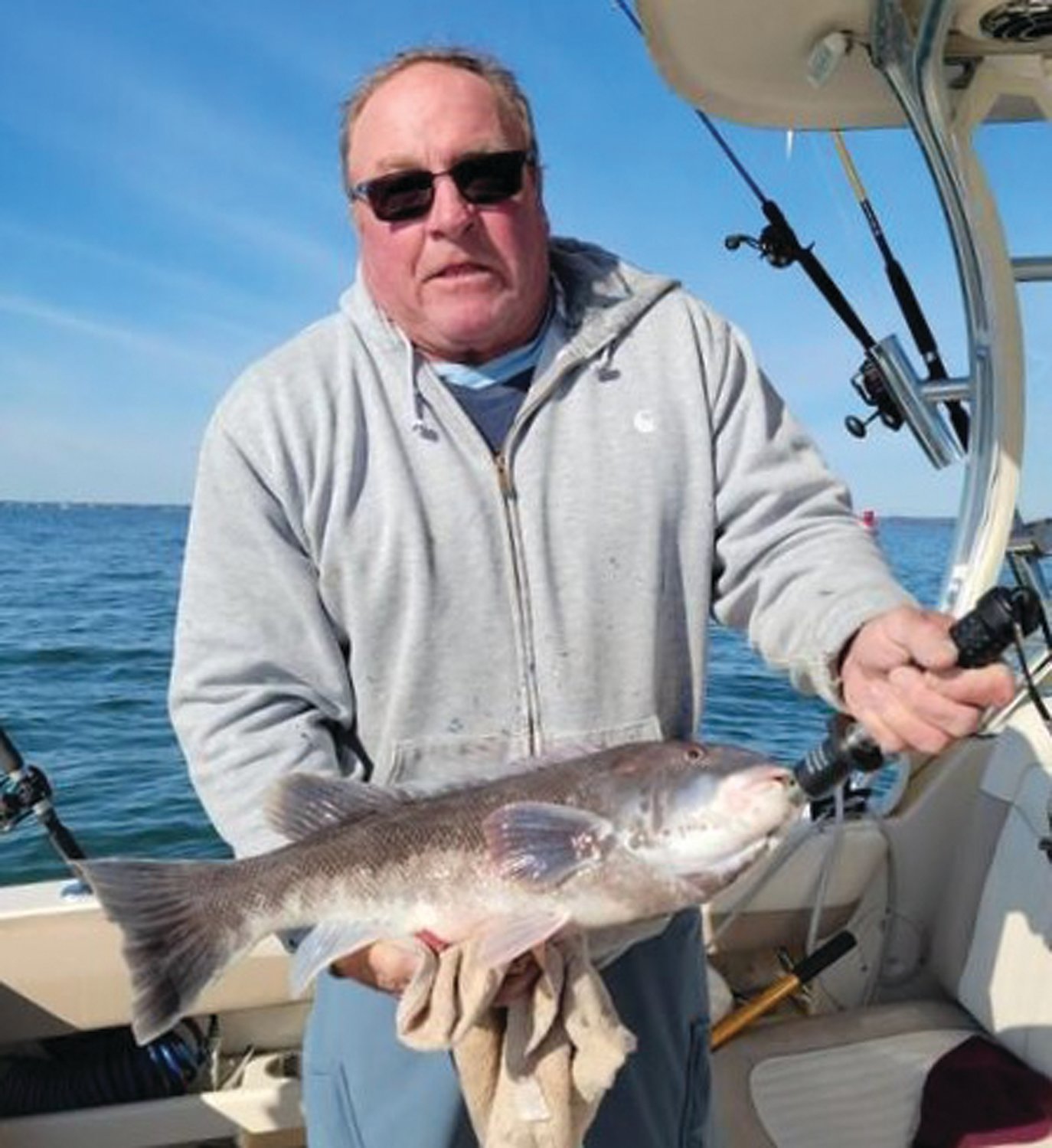 TAUTOG BITE: Kevin Harrington of Portsmouth, RI with the 24-inch, 8.3-pound tautog he caught last week fishing at the mouth of the Sakonnet River with Greg Spier.